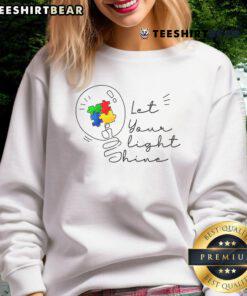 Pretty Autism Awareness sweatshirt featuring 'Let Your Light Shine' design with colorful puzzle pieces, promoting acceptance.
