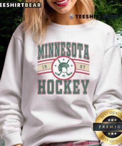 Vintage 1997 Minnesota Hockey sweatshirt featuring bold graphics, perfect for fans of Minnesota's ice hockey history.