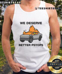 Alt Text: Person wearing 'We Deserve Better' Psyops tank top, showcasing a bold message on casual summer attire.