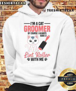 Cute cat groomer wearing a stylish hoodie, gently washing a kitten, showcasing pet grooming expertise and care.