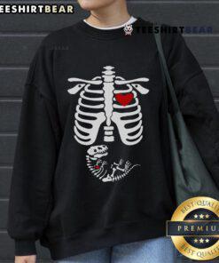 Funny pregnant Halloween costume featuring a dinosaur skeleton design on a cozy sweatshirt for expecting moms.