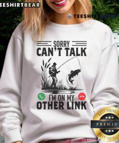 Funny 'Sorry Can't Talk, I'm On My Other Line' fishing sweatshirt design featuring a comical fishing theme.