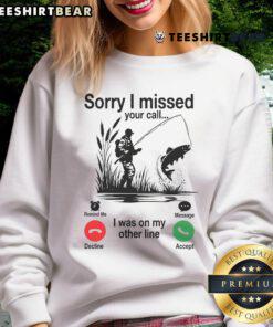 Funny 'Sorry I Missed Your Call, I Was On My Other Line Fishing' sweatshirt displayed on a model by a lake.