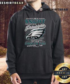 Fan wearing 'Good I Am A Knight' hoodie supporting Philadelphia Eagles, showcasing team spirit wherever they are.