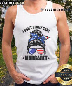Minimalist tank top featuring 'Good I Don't Really Care' by J.D. Vance, styled with a messy bun hairstyle.