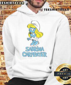 Sabrina Carpenter wearing a stylish Smurfs hoodie, showcasing trendy fashion and vibrant blue character graphics.
