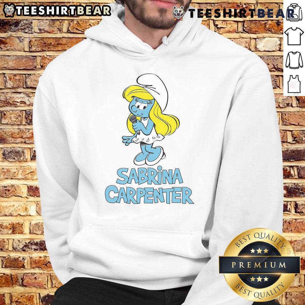 Sabrina Carpenter wearing a stylish Smurfs hoodie, showcasing trendy fashion and vibrant blue character graphics.