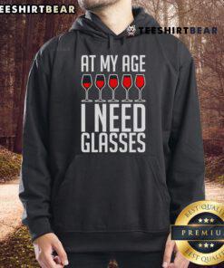 Cozy hoodie with 'Nice At My Age I Need A Glass Wine' print, perfect for wine lovers and casual wear.