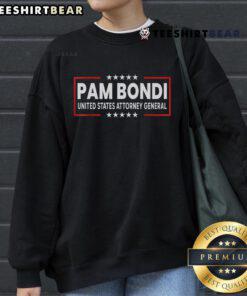 Pam Bondi wearing a United States Attorney General DOJ sweatshirt, showcasing her role in law enforcement.