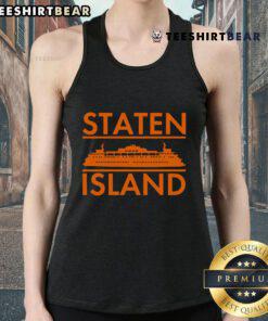 Person wearing a Nice Staten Island Ferry New York tank top with the ferry in the background, showcasing NYC's iconic scenery.