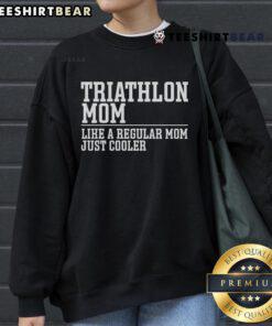 Triathlete mom in a stylish sweatshirt, showcasing swim, bike, run passion for triathlon enthusiasts.
