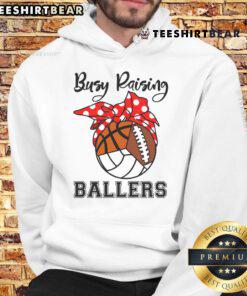 Official Busy Raising Ballers hoodie featuring volleyball, football, and basketball designs for sports enthusiasts.