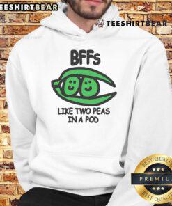Two friends wearing matching 'Top BFFs Like Two Peas In A Pod' hoodies, showcasing their strong bond and playful style.