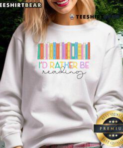 Colorful rainbow sweatshirt saying 'Top Book Lover, I'd Rather Be Reading' perfect for book enthusiasts.