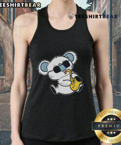 Top koala playing saxophone in a tank top, showcasing musical talent and fun vibes in a vibrant band performance.