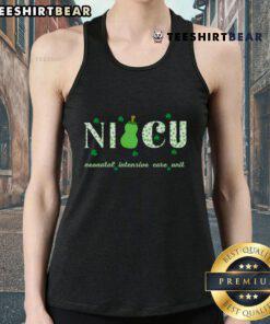 Happy NICU nurse wearing a top retro shamrock tank top for St. Patrick's Day, celebrating with festive spirit.
