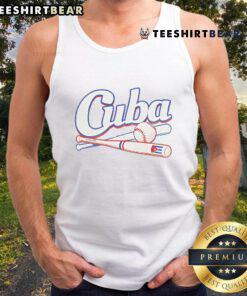 Cuban baseball fan wearing a tank top with the Cuban flag, showcasing team spirit at a vibrant sports event.
