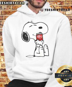 Cute Snoopy hugs a Dr Pepper hoodie, showcasing a playful design perfect for fans of Peanuts and cozy apparel.