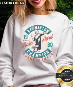 Alt Text: Good Badminton Champion Train Hard 1980 sweatshirt showcasing vintage design and athletic spirit in sportswear.