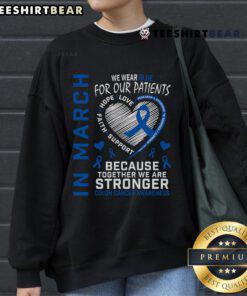 Blue sweatshirt for colon cancer awareness worn by a nurse in March, promoting patient support and education.