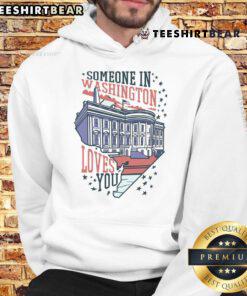 Cozy 'Good Someone In Washington Loves You' hoodie displayed on a hanger, perfect for warm, uplifting fashion.