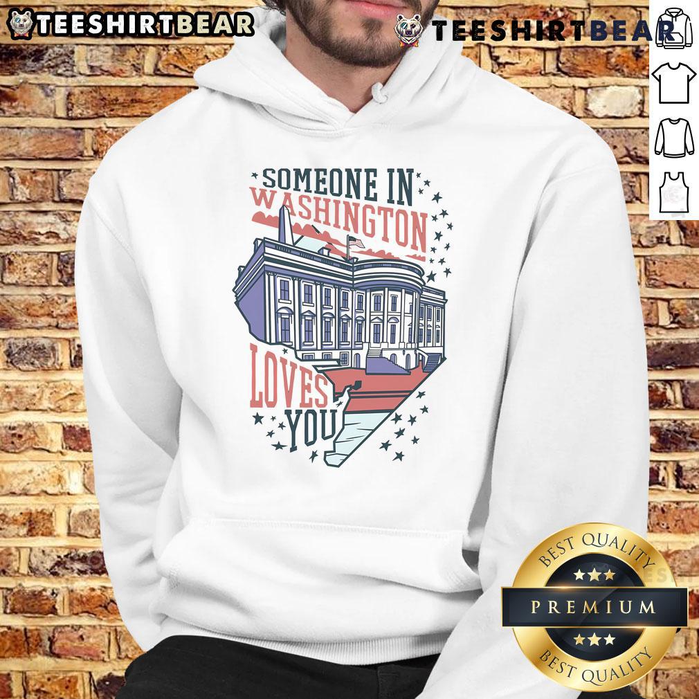 Cozy 'Good Someone In Washington Loves You' hoodie displayed on a hanger, perfect for warm, uplifting fashion.