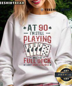 Nice at ninety wearing a playful 90th birthday sweatshirt while enjoying a full deck of cards.