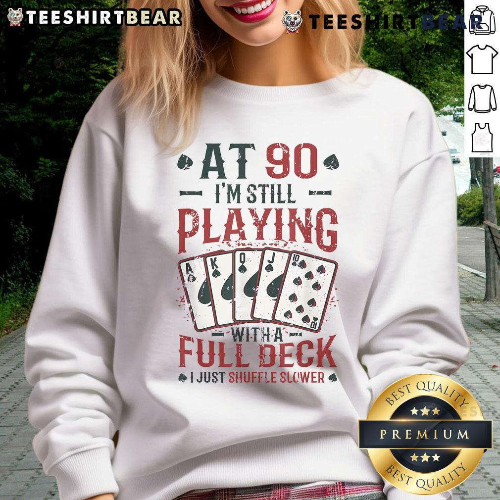 Nice at ninety wearing a playful 90th birthday sweatshirt while enjoying a full deck of cards.