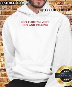 Nice Grandma Droniak wearing a 'Not Flirting, Just Hot' hoodie, smiling warmly in a cozy indoor setting.