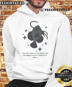 Christian angler fish hoodie featuring 'Nice Light Shines in Darkness' Bible verse for faith-inspired style.