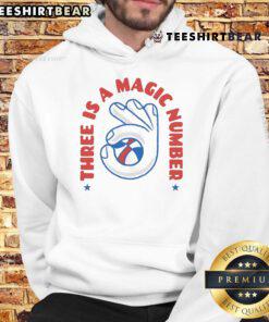 Person wearing a 'Nice Three Is A Magic Number' hoodie, showcasing vibrant design and cozy fit in a casual setting.