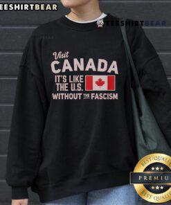 Cozy sweatshirt featuring 'Visit Canada: Like the US Without the Fascism' slogan, perfect for expressing your love for Canada.