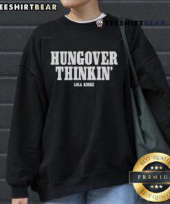 Lola Kirke wearing the Official Hungover Thinkin Sweatshirt, showcasing a stylish and relaxed look.