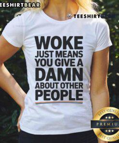 Pride ladies tee featuring 'Official Woke Just Means You Give A Damn About Other People' slogan in vibrant colors.