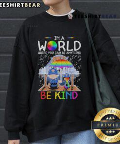 Pretty Charlie Brown and Snoopy New York Knicks sweatshirt with 'In a world where you can be anything, be kind' slogan.