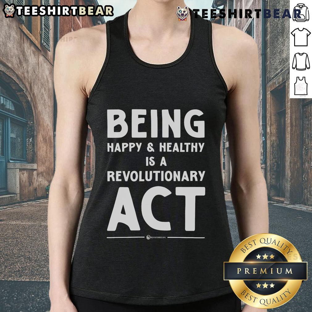 Model wearing a tank top with 'Being Happy and Healthy is a Revolutionary Act' slogan, promoting wellness and positivity.