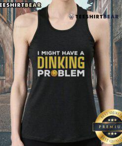 Pickleball player wearing 'I Might Have A Dinking Problem' tank top, showcasing passion for pickleball on the court.