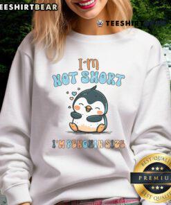 Funny 'I Am Not Short, I Am Penguin Size' sweatshirt design featuring a lazy penguin, perfect for penguin lovers.