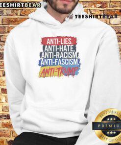 Alt Text: Person wearing a Good Anti-Hate hoodie at a protest against racism and fascism during a Trump rally.