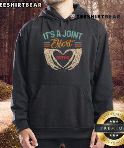Good orthopedic surgeon in 'It's a Joint Effort' hoodie, showcasing teamwork with ortho nurse in a clinical setting.