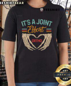 Good orthopedic surgeon and ortho nurse collaborating; 'It's a Joint Effort' tee highlights teamwork in orthopedic care.