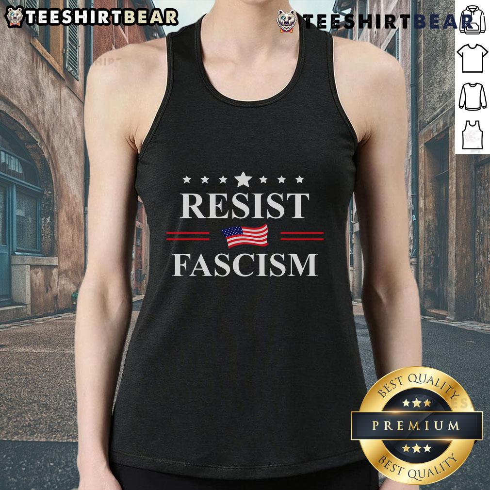 Person wearing a 'Good Resist Fascism No Kings' tank top at an anti-fascism protest, promoting resistance against fascism.