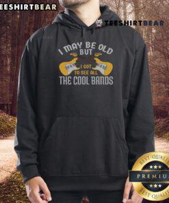 Happy person in a guitar hoodie celebrating their love for music and iconic bands, showcasing vintage style.