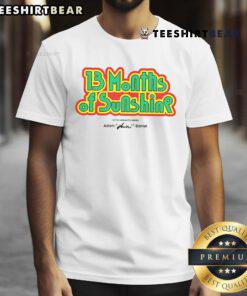 Nice 13 Months of Sunshine T-shirt designed by Adam Huini Daniel, featuring vibrant graphics and catchy lyrics.