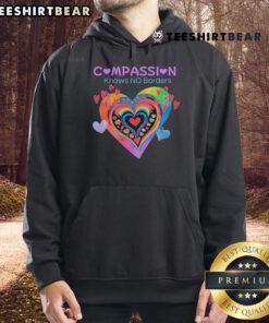 Alt Text: Cozy 'Pretty Compassion Knows No Borders' hoodie featuring heart designs, perfect for spreading love and kindness.