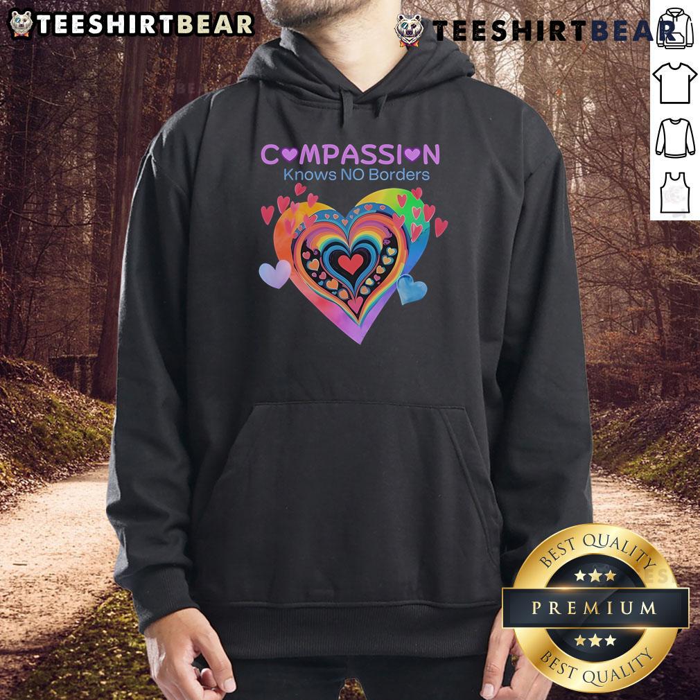 Alt Text: Cozy 'Pretty Compassion Knows No Borders' hoodie featuring heart designs, perfect for spreading love and kindness.