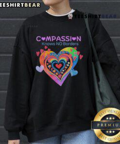 Pretty Compassion Knows No Borders sweatshirt featuring heart designs, perfect for spreading love and kindness.