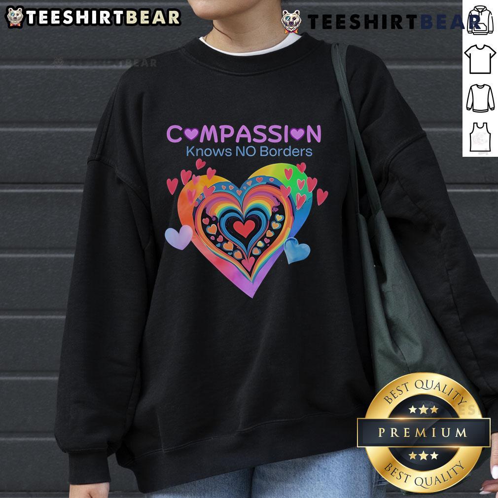 Pretty Compassion Knows No Borders sweatshirt featuring heart designs, perfect for spreading love and kindness.