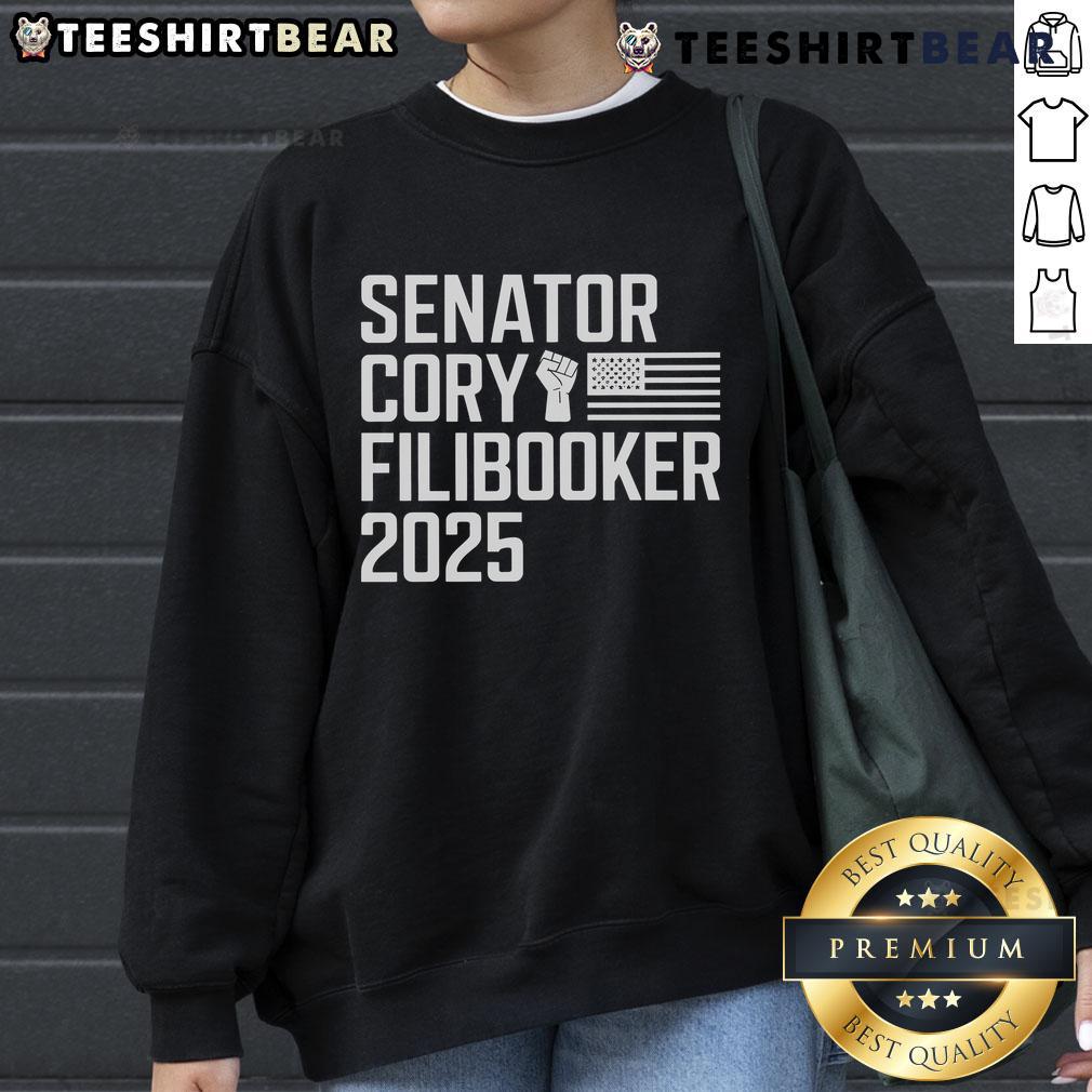Senator Cory Booker wearing a 'Cory Filibooker' sweatshirt during a speech, showcasing his advocacy and style.