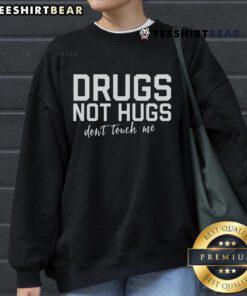 Top Drugs Not Hugs Don't Touch Me sweatshirt design featuring bold lettering on a cozy fabric background.